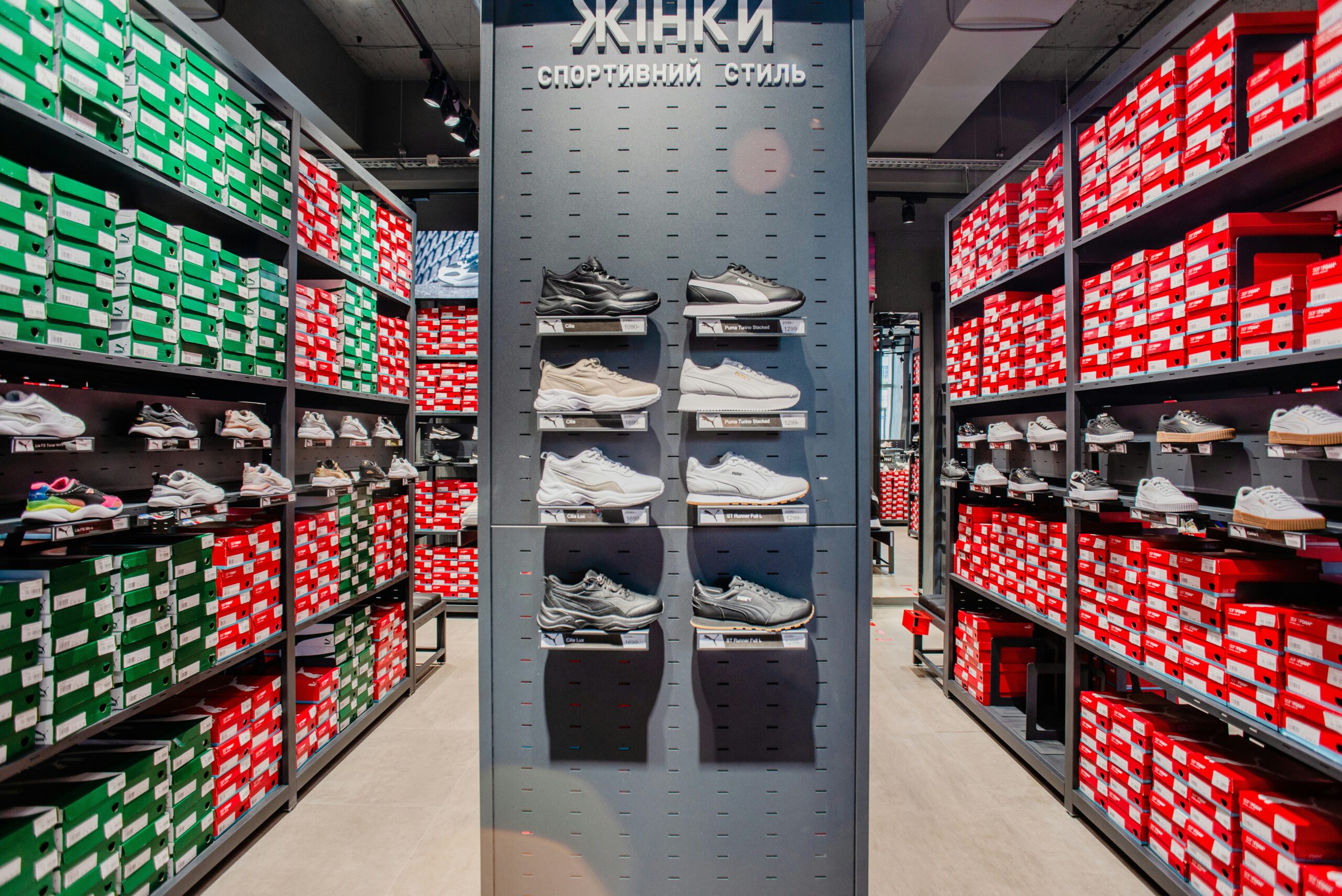 Modern retail interior featuring sleek custom metal display racks showcasing shoes and products