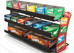 Metal snack display rack with multiple shelves holding various packaged snacks
